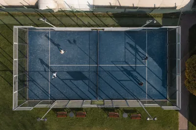 Top view people playing paddle tennis